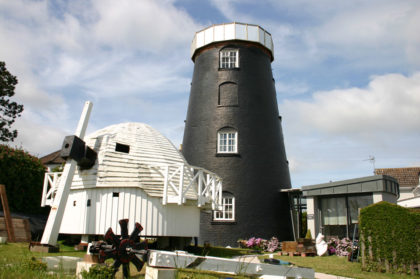 Old cap lowered to ground ready for restoration work and temporary roof in place on mill